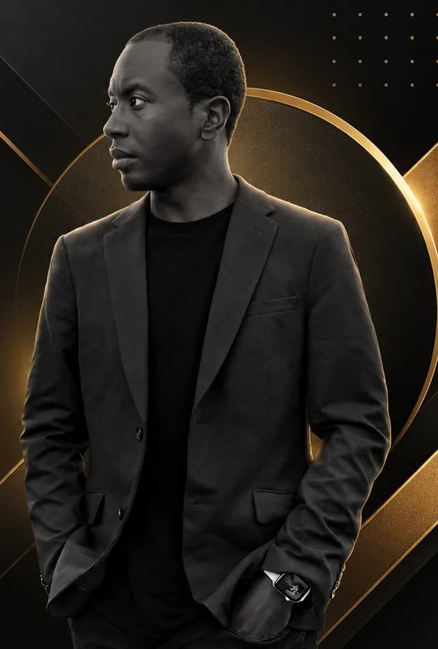 Trevor Washington in a dark blazer, looking to the side